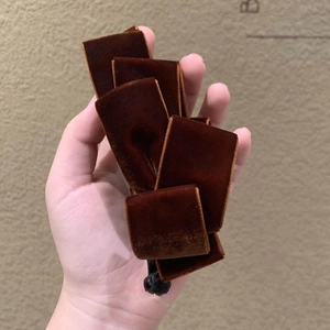Detailed macro view showing premium brown velvet texture and structure of the banana hair clip
