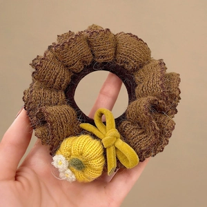 Brown knitted scrunchie with handmade yellow pumpkin and white flower for hair