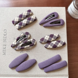 Elegant purple plaid fabric hair clip set including BB clips on a minimalist beige background