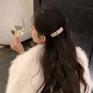 Elegant rhinestone non-slip hair comb shown on brunette wavy hair for high cranial top look