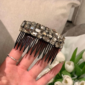 Close-up of elegant hair comb featuring sparkly grey rhinestones and non-slip teeth
