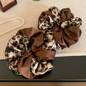 Brown leopard print satin scrunchies set for women shown in elegant vintage style setup