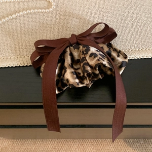 Elegant leopard print scrunchie with silk bow tie and decorative pearl accents