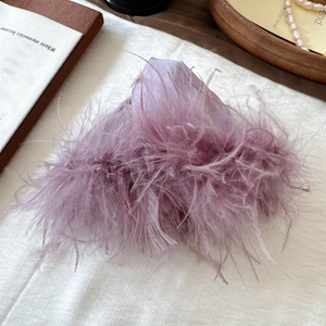 Elegant purple feather hair claw clip for women in a vintage aesthetic setting