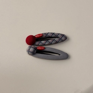Detail of blue and gray plaid fabric hair clips set with unique textured patterns