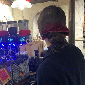 Elegant wine red velvet bow banana clip for a high ponytail hairstyle shown on a model