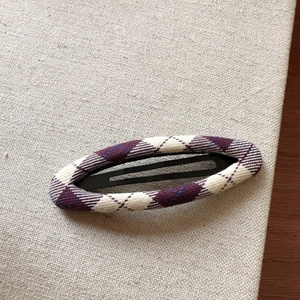 Close-up of a Korean style purple plaid fabric hair clip with argyle knit texture