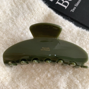 Glossy olive green acetate hair claw clip with golden Barrette la France logo lettering