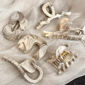 Elegant cream marble acetate claw clips in heart and geometric shapes for women