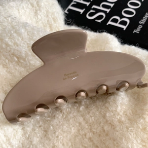 Macro shot of large mocha brown acetate hair claw with Barrette La France gold lettering