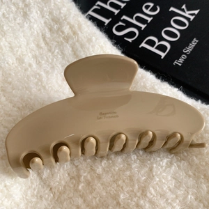 Detail view of khaki large acetate hair claw clip with golden Barrette La France text