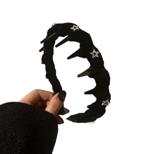 Black velvet headband with spiked trim and rhinestone stars in a dark punk style