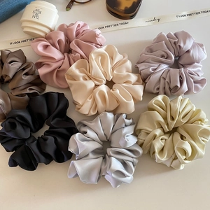 Elegant satin scrunchie set in assorted cream colors for a chic French aesthetic