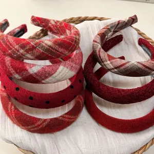 Elegant red plaid and textured winter headbands in a rustic basket for styling