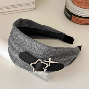 Detail of grey wide headband featuring a black leather strap and silver star cross charms