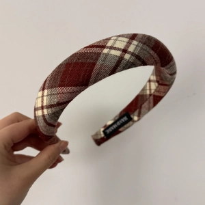 Detail showing the red and white checkered fabric and Handmade label of the headband