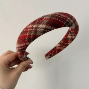 Close-up detail of the red plaid thick padded headband fabric and textured weaving