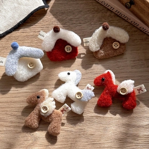 Minimalist red plush horse and house brooch pin set on light wood background