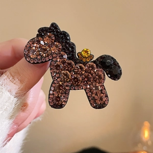 Macro shot of luxury red horse hair clip featuring amber crystals and golden flower accents