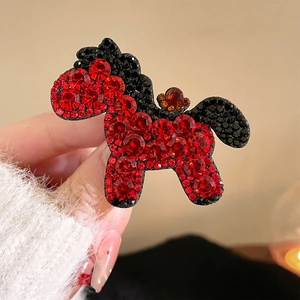 Sparkling red crystal pony hair clip with premium rhinestones held in hand