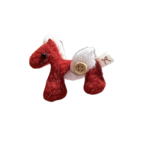 Handmade red felt pony brooch with white fluffy details and a rustic wooden button
