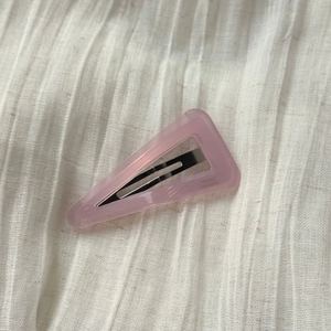 Close-up of pink acetate triangle hair clip with FRANCE Handmade text engraving