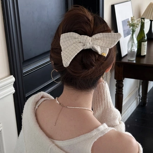 Elegant cream tweed bow hair clip for women featuring a minimalist luxury aesthetic