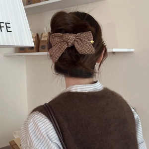 Elegant dark brown tweed bow hair clip for women, vintage style accessory on bun hair