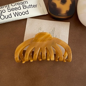 Detailed view of the amber marble acetate claw clip on an aesthetic background
