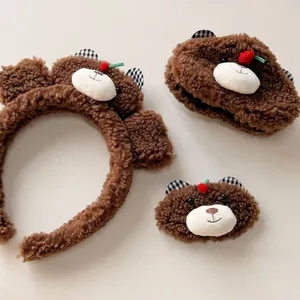 Detailed view of the brown teddy fleece bear hair accessories set with checkered ears