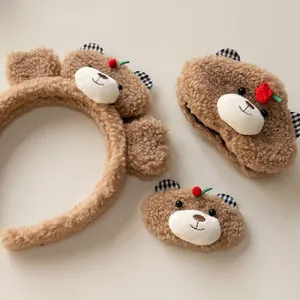 Detailed view of plush bear hair accessories including headband, scrunchie and clip