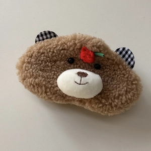 Detailed view of the cute brown plush bear hair clip with red strawberry embroidery