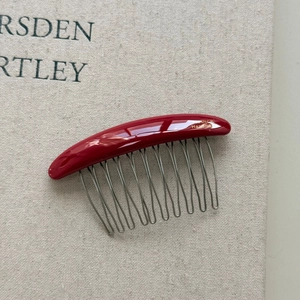 Minimalist red handmade hair comb with gold lettering and silver metal U-shaped teeth