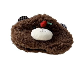 Cute brown plush bear hair clip with checkered ears and red cherry detail on white background
