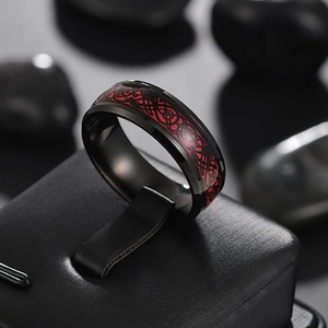 Macro detail of men's black titanium dragon pattern ring on leather display stand