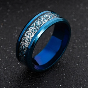 Detail of blue titanium steel ring featuring silver Celtic dragon pattern and blue glitter