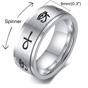 Macro shot of spinner ring with engraved Eye of Horus and Ankh symbols on 8mm steel band