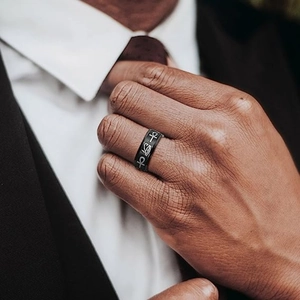 Detail of rotating matte black spinning ring with silver Ankh and Eye of Horus symbols