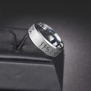 Macro shot of the Viking Rune patterns and brushed metal texture on a wide mens band