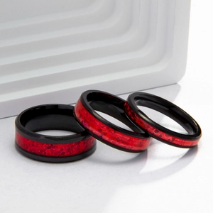 Three titanium steel rings with black matte edges and red faux opal honeycomb inlays