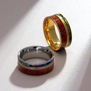 Detail of titanium steel men's ring with abalone shell and wood inlay textures
