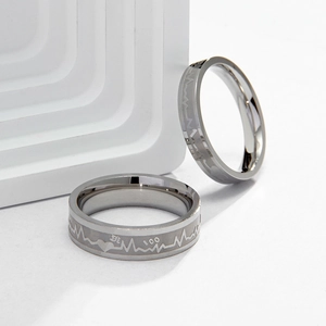 Polished titanium steel couple rings with engraved EKG heartbeat and heart patterns