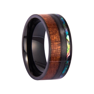 Detailed macro view of wood grain and colorful abalone shell inlays on black steel ring