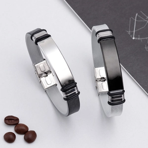 Detailed macro view of silver and black stainless steel mesh bracelets with stamped buckle