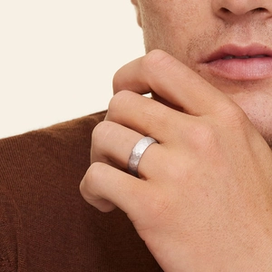 Détail macro d'une bague pour homme en argent martelé portée par un mannequin