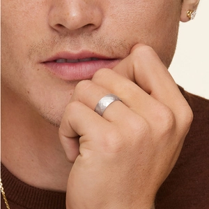Gros plan d'une bague pour homme en argent martelé aux facettes géométriques