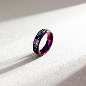 Macro detail of purple galaxy titanium steel ring with rainbow shell inlay and gradient finish