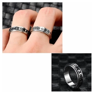 Detail view of two spinner rings with moon star and floral patterns for anxiety relief