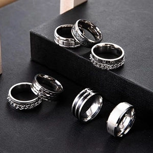 Detailed macro view of seven stainless steel rings with rotating chain and Roman numerals
