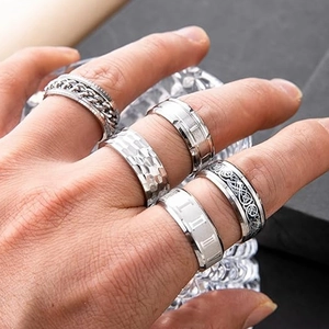 Macro shot of stainless steel spinner rings with Roman numerals and Celtic patterns